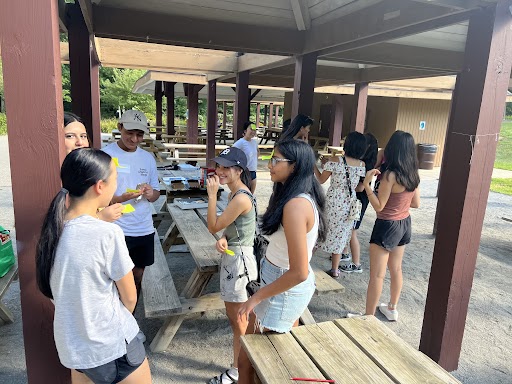 ALLY Michigan 2022 team chatting around picnic tables